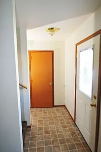 A hallway with a door and tiled floor