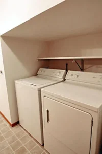 A washer and dryer in the corner of a room.