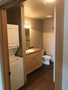 A bathroom with a washer and dryer in it