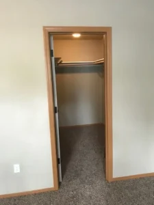 A closet with lights on the inside of it